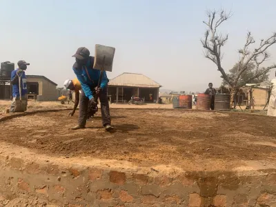 Community members flatten the foundation for a new Hello Hub in Dakwa. Photo courtesy of Hello World and CITAD. image linking to Community networks newsletter: Creating connectivity models to support life and the future of the Earth